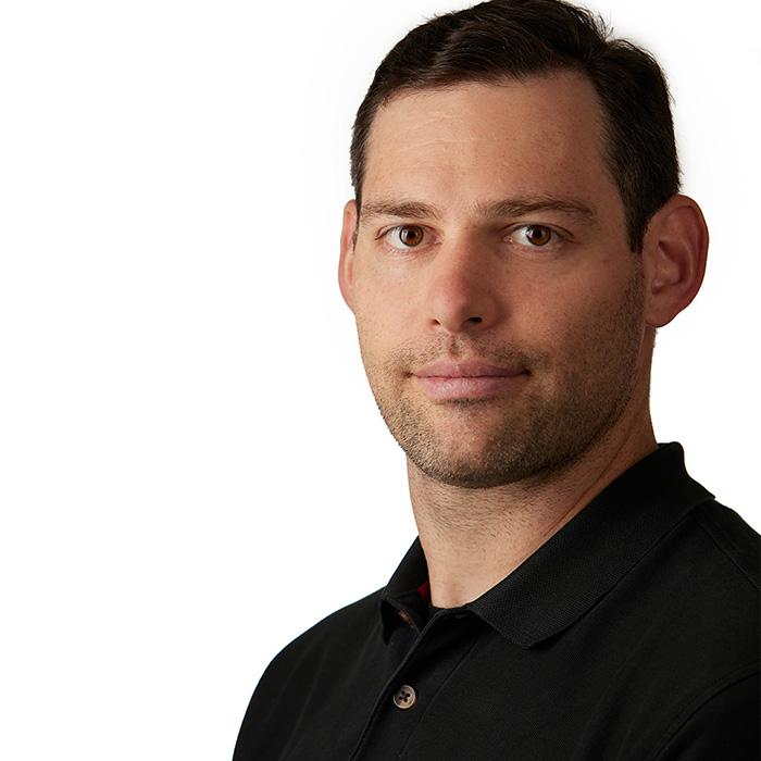 headshot Matt right side of the frame with a dark polo shirt on a white background by M Carter Photography